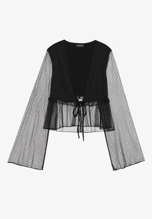 Zwarte cropped blouse met doorschijnende mouwen van polkadots en een striksluiting in de taille. Dit ontwerp heeft een V-hals en klokmouwen.