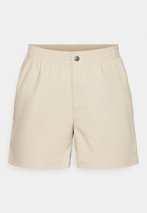 Bežid lühikesed püksid, mis on valmistatud kergest kangast, elastse vöökoha, esikottide ja ühe nupuga kinni, meeldiva sileda tekstuuriga.