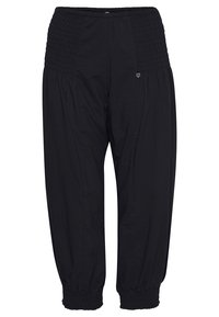 Pantalon noir coupe ample avec taille et poignets smockés élastiques, avec un petit logo discret en haut de la cuisse.