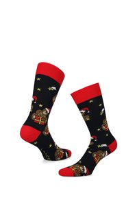 Czarne skarpetki z czerwonymi akcentami, z nadrukiem kolorowych niedźwiadków w czapkach Świętego Mikołaja, gwiazdek i wzorów prezentów. Wykonane z miękkiego, elastycznego materiału.