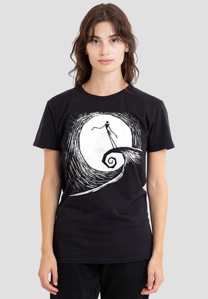 Black cotton t-shirt featuring a white graphic of a figure standing on a spiraled branch against a circular background. Short sleeves, crew neckline.