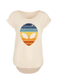 Beige short-sleeve shirt with a retro-styled, striped alien head graphic in blue, yellow, orange, and red tones on the front.
