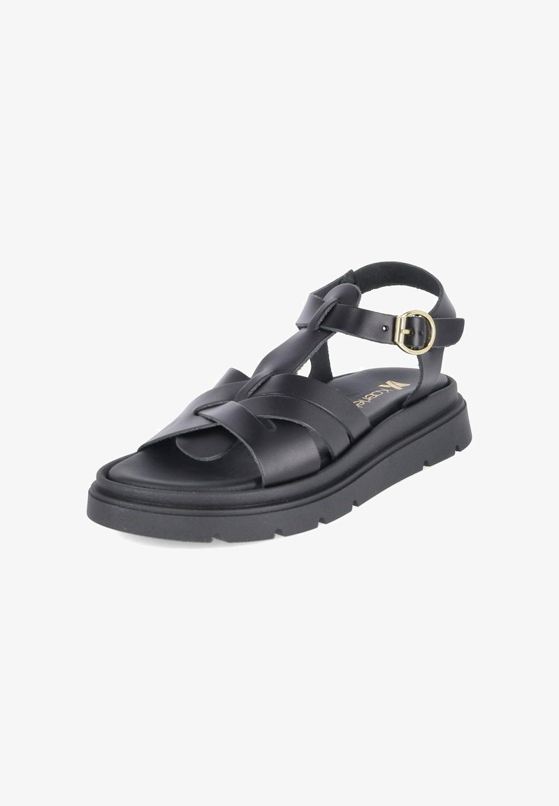 Sandale en cuir noir avec brides tressées, boucle dorée réglable sur la bride de cheville et semelle épaisse rainurée pour un usage décontracté.