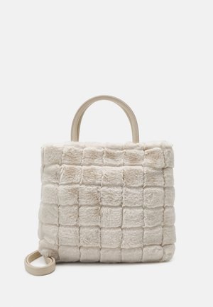 Beige faux fur handbag with square quilted pattern, top handles, and detachable shoulder strap on a white background.