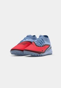 Pair of red and light blue Nike athletic shoes with high collar and textured sole, shown against a plain white background.