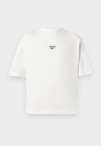 Bijela majica kratkih rukava od pamuka, s malim crnim Reebok logotipom na gornjem dijelu leđa, s opuštenim krojem i jednostavnim dizajnom.