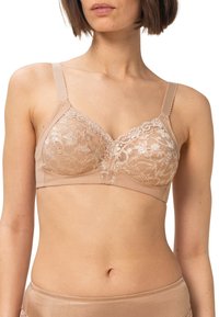 Beige blonde bralette med blomstermønster, justerbare stropper og en glat bånd. Har en V-formet udskæring og delikat kant.