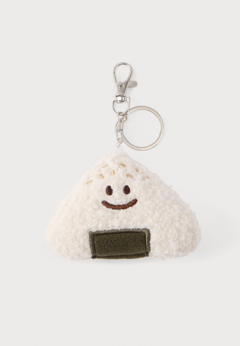 Portachiavi morbido e soffice a forma di onigiri, bianco con un volto sorridente e cuciture marroni. Presenta un dettaglio in feltro verde. Chiusura metallica.