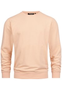 Peachfarvet sweatshirt med rund hals, lange ærmer, ribbede manchetter og bundkant. Har et lille broderet logo på brystet.