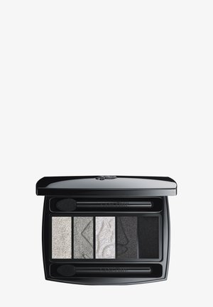 Black rectangular eyeshadow palette featuring four shades: silver, gray, and black, with two applicators. Textured finishes on some shades.