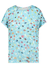 Kurzarmoberteil aus hellblauem Stoff mit einem verstreuten Punktmuster in verschiedenen Farben. Weicher Stoff, lockere Passform und runder Ausschnitt.