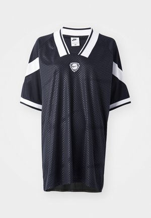 Maillot de sport de la marine en tissu maillé respirant. Présente des rayures blanches sur les manches et un logo Nike rond sur la poitrine. Design à motif texturé.
