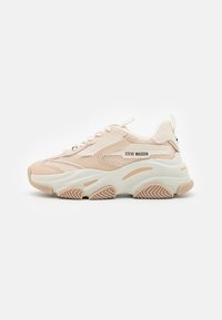 Zapatilla de color rosa claro con paneles de malla y acentos blancos. Cuenta con una suela gruesa y fondo de goma texturizada. Nombre de la marca "Steve Madden" visible.