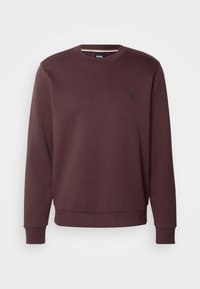 Sudadera burdeos de tela suave, con cuello redondo, puños y dobladillo acanalados, y un pequeño logo en el pecho.