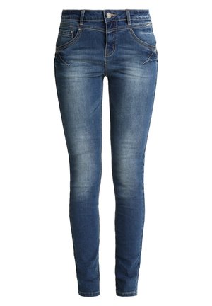 Jean skinny en denim bleu foncé avec un aspect délavé. Comprend cinq poches, une fermeture éclair et des accents de couture discrets sur les coutures des poches.