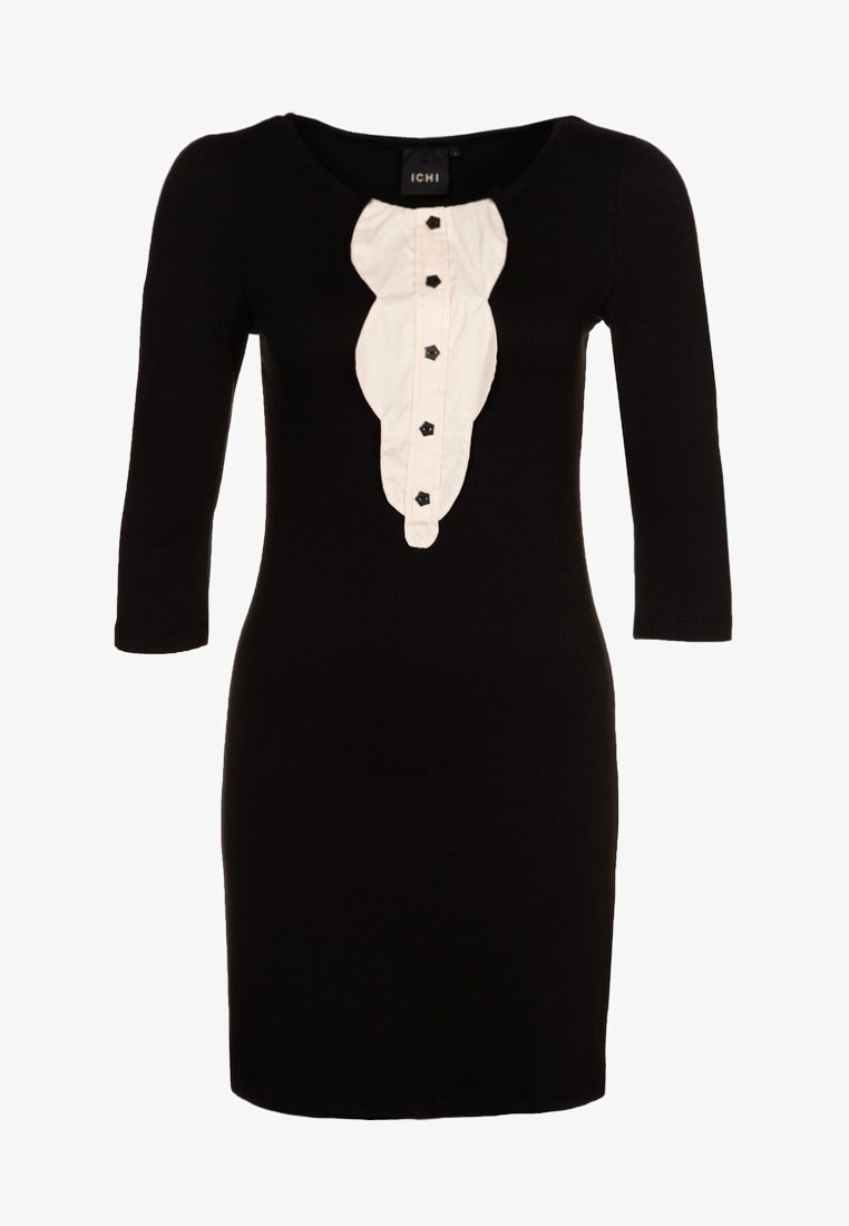 Svart klänning med tre fjärdedels ärmar, prydd med en vit krage med volanger och svarta knappar ned längs framsidan. Tillverkad av ett mjukt tyg.