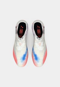 Puma athletic shoes with a white knit upper transitioning to pink and blue at the toe. Features tonal laces and a padded tongue.