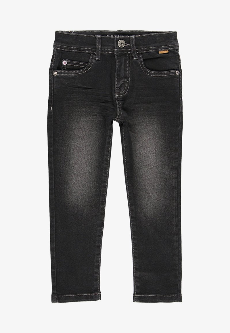 Tejanos de mezclilla negra con un corte ajustado, que presentan costuras en contraste, cinco bolsillos y un cierre de cremallera con botón. Tiro limpio.