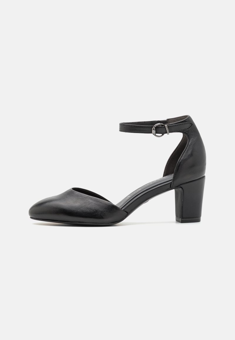 Scarpa nera in pelle con tacco alto, punta aperta e cinturino alla caviglia, caratterizzata da un tacco spesso e una texture liscia.