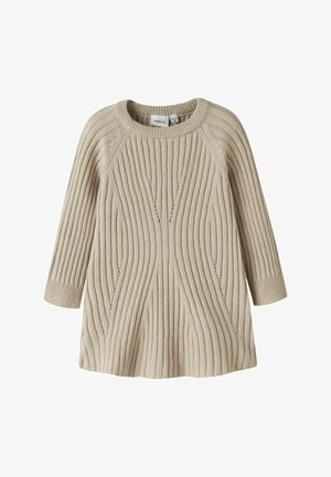 Beežist kangast kudum, millel on sooniline tekstuur, ümar kaelus ja kolmeveerandi varrukad, flared keha ning dekoratiivsed jooned.