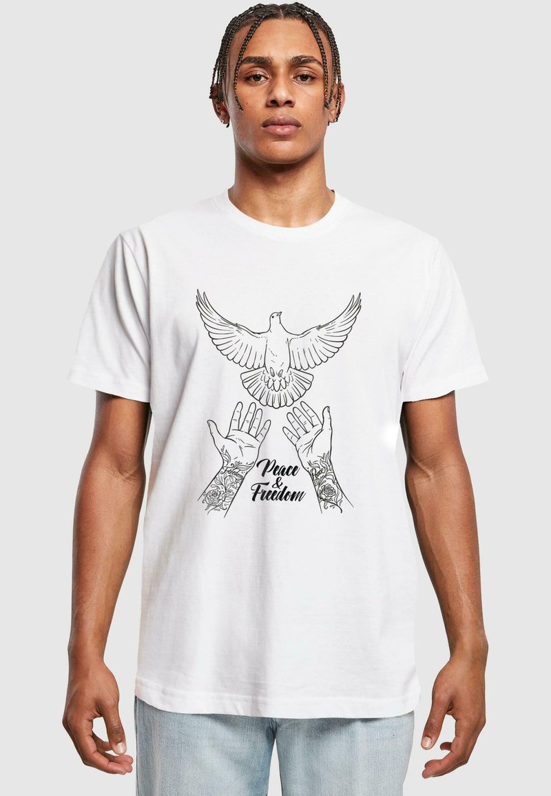 White cotton T-shirt featuring a black illustration of a dove above two hands with rose tattoos and the text "Peace & Freedom."