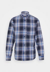 Camicia flanella a quadri in navy, azzurro chiaro e bianco. Caratterizzata da chiusura con bottoni, colletto e una tasca sul petto.