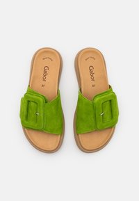 Sandales à glissière en suede vert avec une large sangle dotée d'une boucle rectangulaire, semelle intérieure en tan et semelles en caoutchouc. Taille 37.