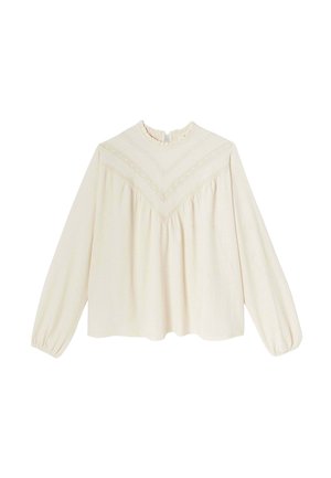 Blouse à manches longues couleur crème avec un col à volants, en tissu texturé, et un motif de broderie décoratif en forme de V à l'avant.