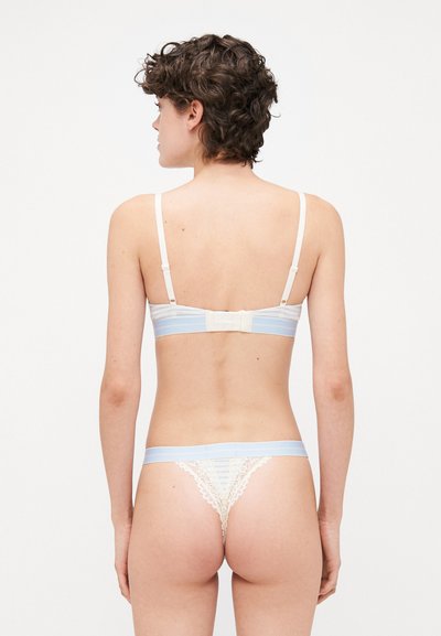 Lace-trimmed bra and thong set featuring light blue and cream colors, adjustable straps, and a hook-and-eye closure at the back.