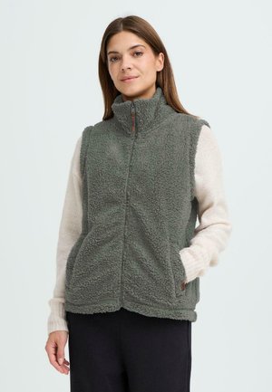 Fleece vest i dæmpet grøn med høj krave, frontlynlås og sidelommer. Struktureret overflade med et blødt, varmt udseende.