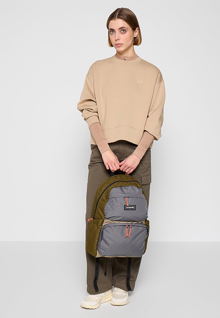 Rucksack mit einer olivgrünen und grauen Farbgestaltung, ausgestattet mit verstellbaren Trägern, zwei vorderen Reißverschlusstaschen und einer strapazierfähigen Stoffoberfläche.