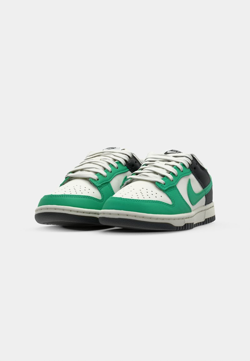 Baskets en cuir vert et blanc avec des accents gris, à laçage, avec un bout perforé et une semelle en caoutchouc texturée. Logo Nike sur le côté.