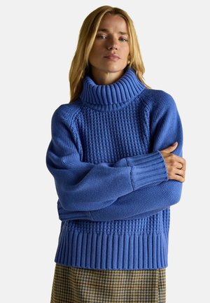 Blauer gestrickter Pullover mit einem dicken gerippten Rollkragen, strukturiertem Oberteil und weiten Ärmeln. Verfügt über eine Mischung aus Strickmustern und gerippten Bündchen.