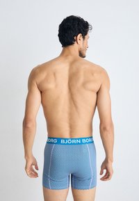 Men's blue striped boxer briefs with a blue waistband featuring the brand name "BJÖRN BORG." Smooth fabric with a form-fitting design.