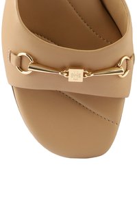 Beige slipper sandalen gemaakt van glad leer, met een gouden ketting-accent en een vierkant logo. Ronde neus en een minimalistisch ontwerp.