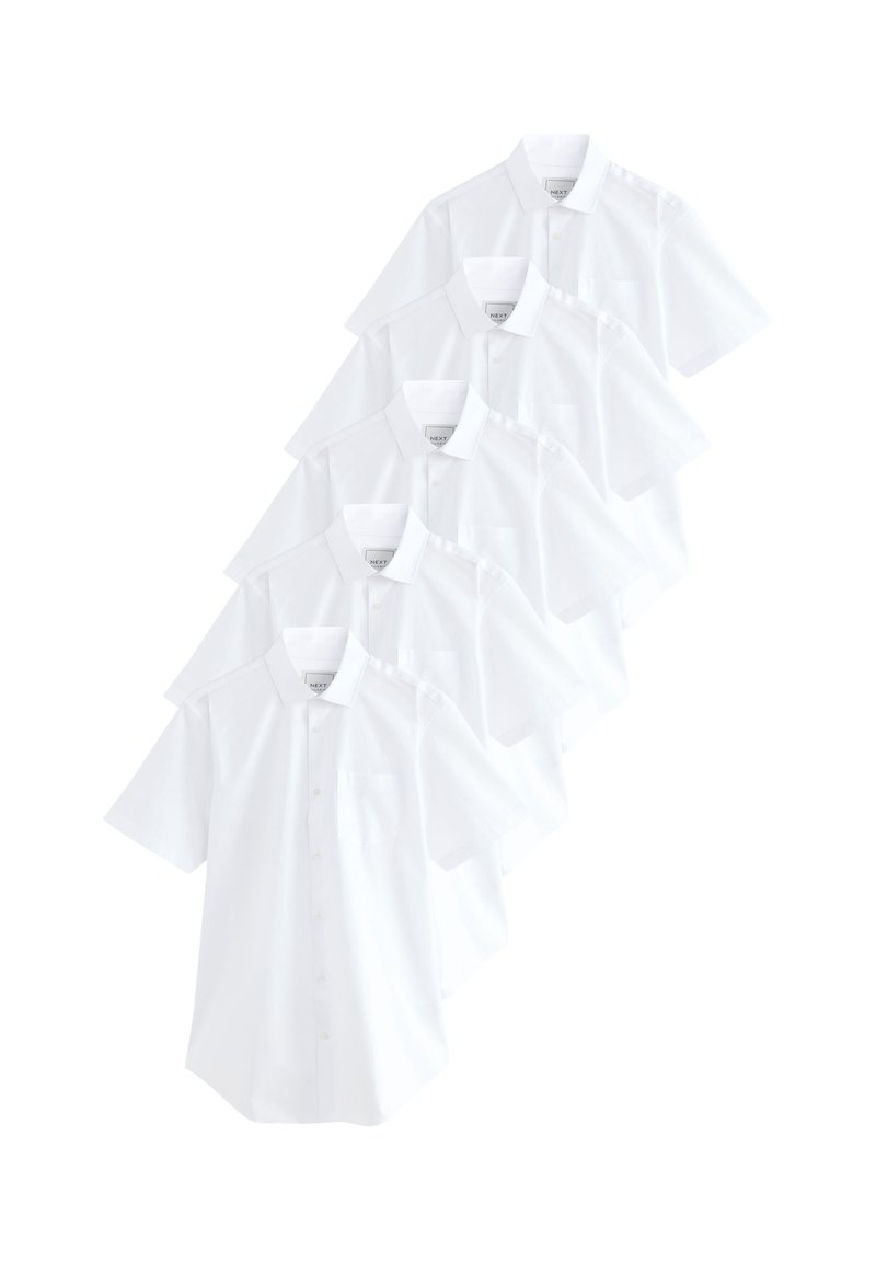 Chemises blanches à manches courtes empilées, présentant des boutons sur le devant, des cols pointus et une petite poche sur le côté gauche.
