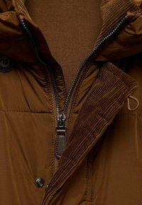 Brown insulated jacket with a corduroy collar. Features a zippered front, brown zipper pull, and a snap button closure. Lined interior visible.