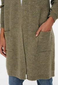 Olive green knitted cardigan with a loose fit, featuring ribbed pockets and cuffs, textured fabric, and open front design.