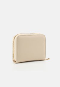 Beige leather wallet with a smooth texture, rectangular shape, rounded edges, and gold zipper hardware. Features a small zipper pull tab.