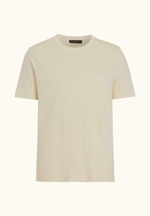 Lyhythihainen, pyöreäkauluksinen beige T-paita, jossa on resorikaulus, esitetty yksinkertaisella vaalealla taustalla.