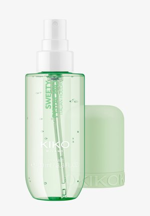 Flacon spray vert transparent de Kiko Milano Sweetly Pistachio body mist avec pompe blanche et bouchon vert assorti détaché.