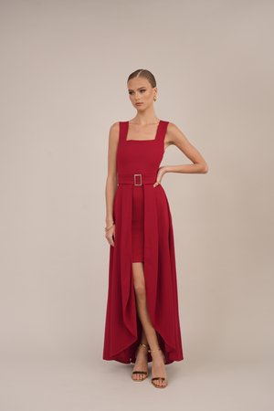 Red dress with a square neckline, fitted bodice, and a flowing skirt. Features a central belt and slit. Smooth fabric and elegant design.