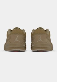 Καφέ σουέντ χαμηλά αθλητικά παπούτσια με λεία υφή, επενδεδυμένο κολάρο και λευκό λογότυπο Jumpman στη φτέρνα. Καουτσούκ σόλα με σχέδιο πρόσφυσης.