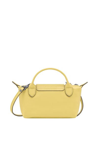 Small yellow leather handbag with short handles and detachable shoulder strap, zipper closure, and subtle embossed brand name on front flap.