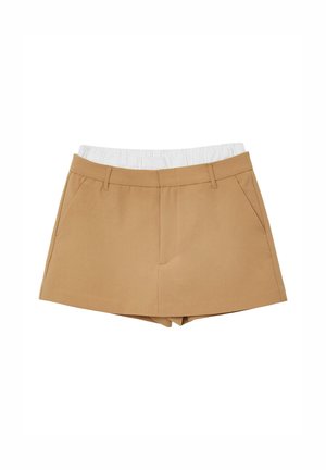 Beige Shorts aus einem Stoff mit angepasster Taille und elastischem weißen Bund. Verfügt über zwei seitliche Taschen und einen klaren Schnitt am Saum.