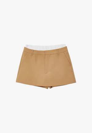 Beige Shorts aus einem Stoff mit angepasster Taille und elastischem weißen Bund. Verfügt über zwei seitliche Taschen und einen klaren Schnitt am Saum.