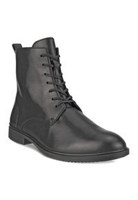 Botas de tobillo de cuero negro con una textura suave, con un diseño de cordones, puntera redondeada y una suela de goma baja para mayor estabilidad.