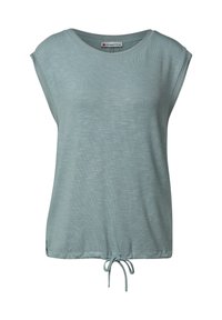 Jasnoniebieska, krótko rękawowa bluzka o luźnym kroju, okrągłym dekolcie i ściągaczu u dołu, co pozwala na regulację długości. Wykonana z miękkiej, teksturowanej tkaniny.