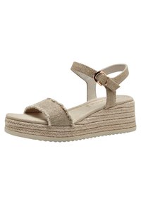 Béžové espadrilové klínové sandály s textilním svrškem, kotníkovým páskem a podrážkou obalenou provázkem. Texturované pásky a zaoblený design špičky.