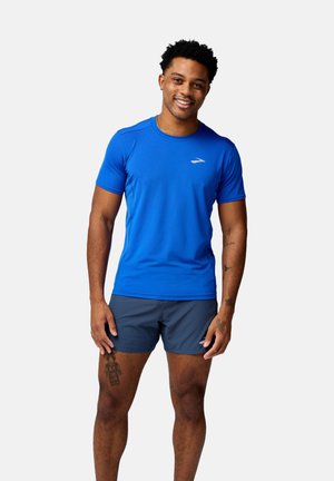 Blue athletic t-shirt made of moisture-wicking fabric with a round neck, short sleeves, and a small reflective logo on the chest.